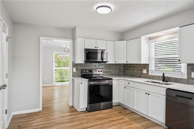 16620 E 36th St, Independence, MO 64055 - kitchen featuring stainless steel appliances, tasteful backsplash, light countertops, and a textured ceiling
