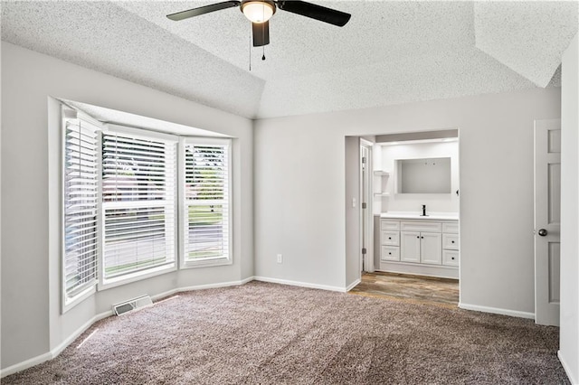 16620 E 36th St, Independence, MO 64055 - unfurnished bedroom with carpet floors, a textured ceiling, ensuite bath, ceiling fan, and lofted ceiling