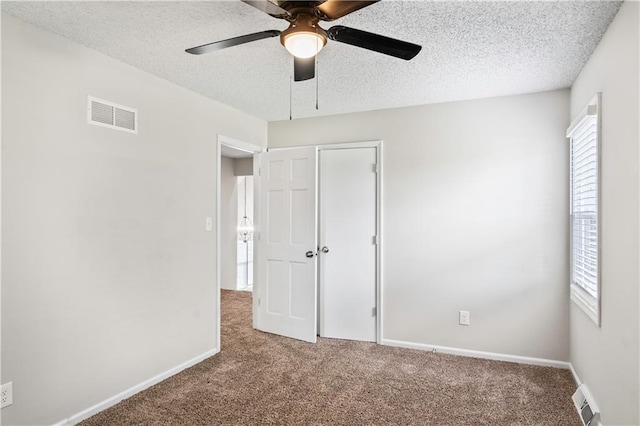 16620 E 36th St, Independence, MO 64055 - unfurnished bedroom with carpet flooring, a closet, a textured ceiling, and a ceiling fan