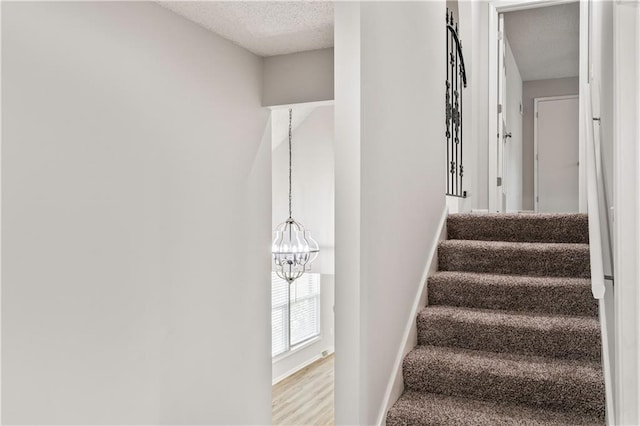 16620 E 36th St, Independence, MO 64055 - stairway with a textured ceiling and a chandelier