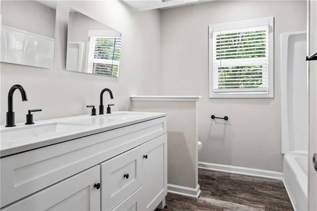 16620 E 36th St, Independence, MO 64055 - bathroom with double vanity, wood finished floors, and shower / tub combination