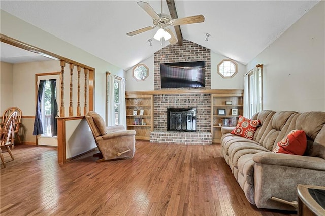 503 SE Brownfield Dr, Lees Summit, MO 64063 - living room featuring a brick fireplace, a ceiling fan, and hardwood / wood-style floors
