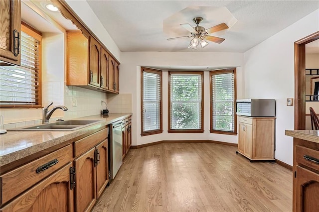 503 SE Brownfield Dr, Lees Summit, MO 64063 - kitchen featuring dishwasher, light wood-style floors, a ceiling fan, and plenty of natural light