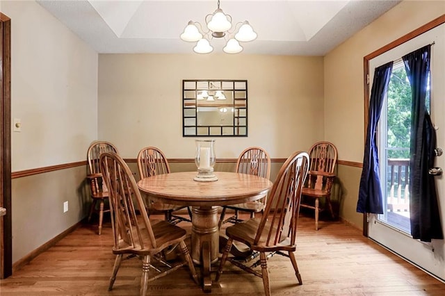 503 SE Brownfield Dr, Lees Summit, MO 64063 - dining space featuring a chandelier, light wood-type flooring, and vaulted ceiling