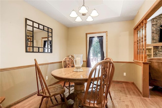 503 SE Brownfield Dr, Lees Summit, MO 64063 - dining area featuring wood finished floors and a chandelier