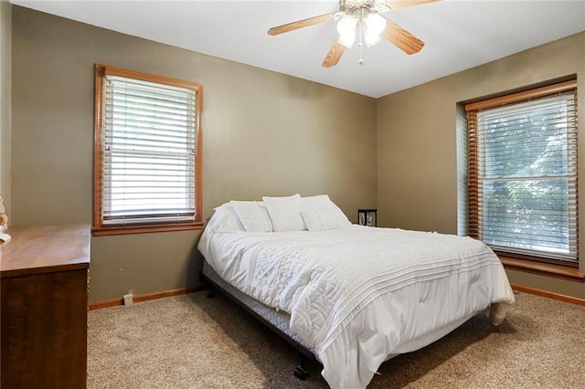 503 SE Brownfield Dr, Lees Summit, MO 64063 - carpeted bedroom featuring multiple windows and a ceiling fan