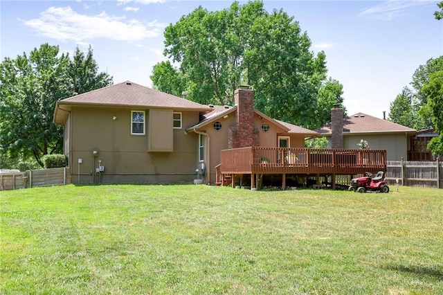 503 SE Brownfield Dr, Lees Summit, MO 64063 - rear view of house with a fenced backyard, a wooden deck, and a chimney