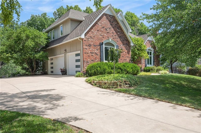 4140 W 131st Ter, Leawood, KS 66209 - view of front of home with brick siding, driveway, board and batten siding, a front yard, and roof with shingles
