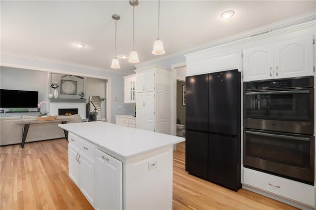 4140 W 131st Ter, Leawood, KS 66209 - kitchen featuring freestanding refrigerator, double oven, white cabinets, light countertops, and a warm lit fireplace