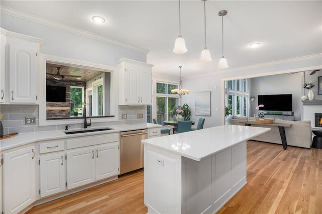 4140 W 131st Ter, Leawood, KS 66209 - kitchen with dishwasher, decorative backsplash, a center island, light countertops, and ornamental molding