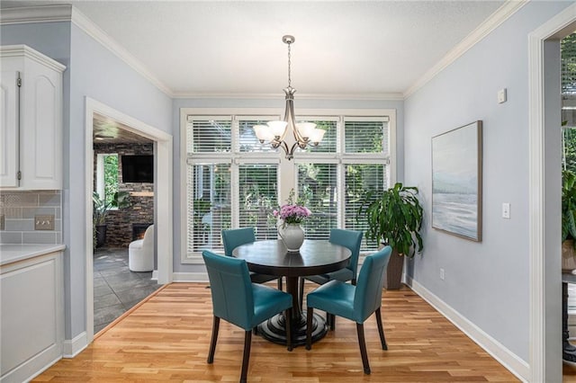 4140 W 131st Ter, Leawood, KS 66209 - dining area featuring a chandelier, light wood finished floors, and crown molding