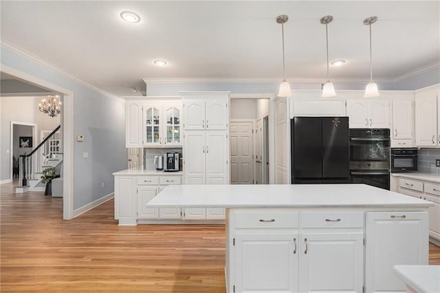 4140 W 131st Ter, Leawood, KS 66209 - kitchen featuring black fridge, stainless steel double oven, backsplash, light wood-style floors, and crown molding