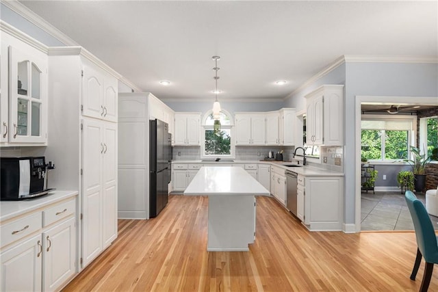 4140 W 131st Ter, Leawood, KS 66209 - kitchen featuring dishwasher, freestanding refrigerator, healthy amount of natural light, light countertops, and ornamental molding