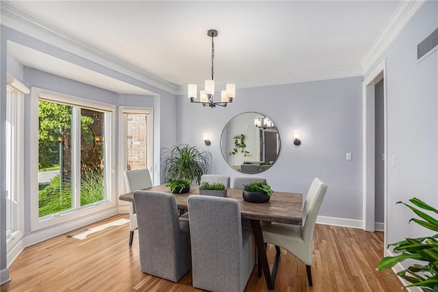 4140 W 131st Ter, Leawood, KS 66209 - dining space featuring a chandelier, light wood finished floors, and ornamental molding