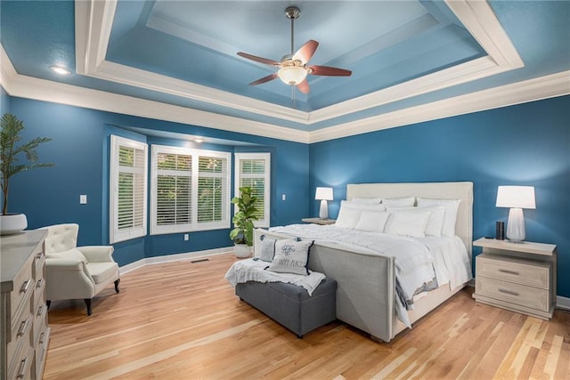 4140 W 131st Ter, Leawood, KS 66209 - bedroom with a tray ceiling, ornamental molding, light wood-type flooring, and a ceiling fan