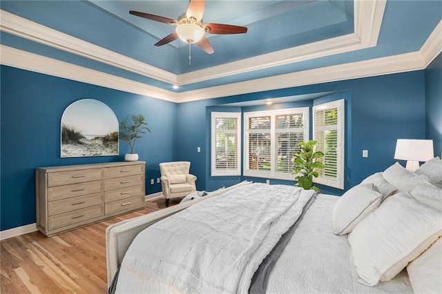 4140 W 131st Ter, Leawood, KS 66209 - bedroom featuring a raised ceiling, ornamental molding, light wood-style floors, and ceiling fan