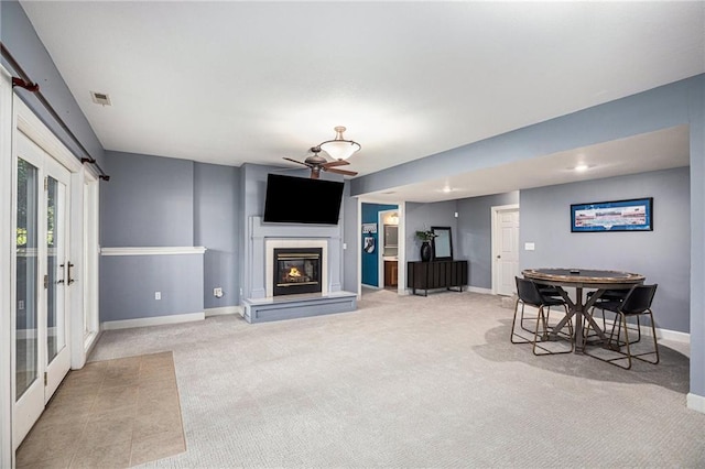 4140 W 131st Ter, Leawood, KS 66209 - living area with a ceiling fan, light carpet, and a glass covered fireplace