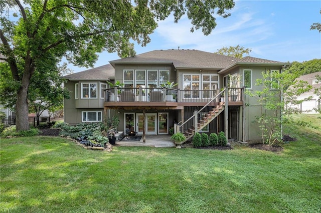 4140 W 131st Ter, Leawood, KS 66209 - rear view of house featuring stairway, a deck, a sunroom, and a lawn