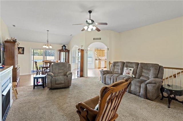21506 Murlo Cir, Peculiar, MO 64078 - living area with arched walkways, lofted ceiling, a ceiling fan, a chandelier, and carpet
