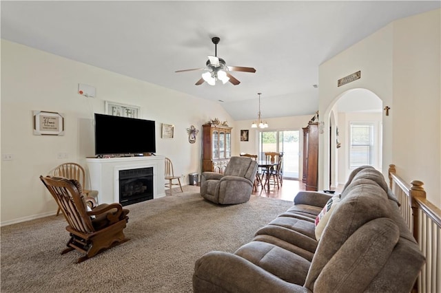 21506 Murlo Cir, Peculiar, MO 64078 - living area featuring ceiling fan, carpet, a fireplace, lofted ceiling, and a chandelier