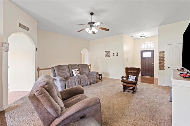 21506 Murlo Cir, Peculiar, MO 64078 - living room featuring arched walkways, a ceiling fan, and carpet