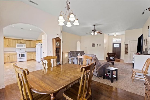 21506 Murlo Cir, Peculiar, MO 64078 - dining space with arched walkways, ceiling fan, light wood-style floors, lofted ceiling, and a chandelier