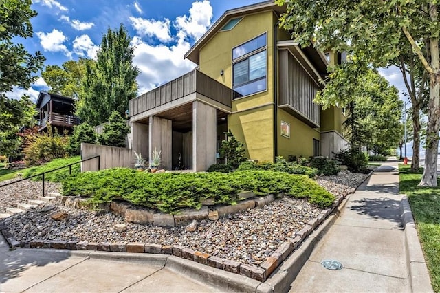 2400 Forest Ave, Kansas City, MO 64108 - view of side of home featuring a balcony and stucco siding
