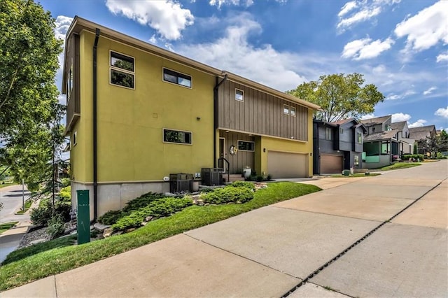 2400 Forest Ave, Kansas City, MO 64108 - view of front of house with driveway, an attached garage, and a residential view