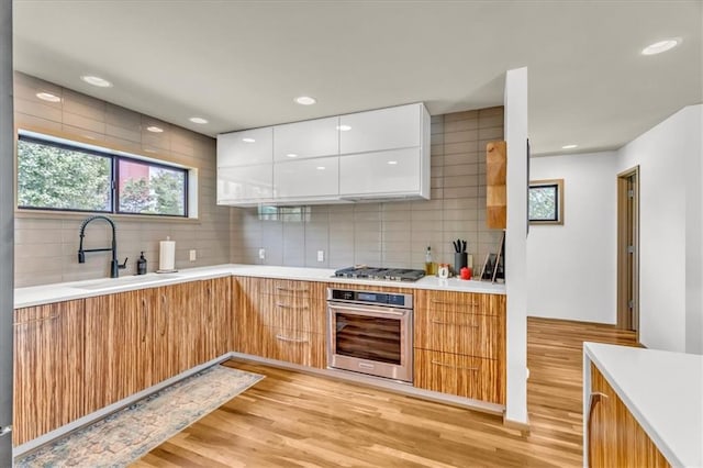 2400 Forest Ave, Kansas City, MO 64108 - kitchen with stainless steel appliances, modern cabinets, light countertops, white cabinetry, and recessed lighting