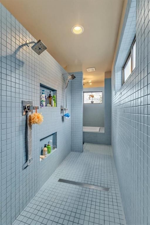 2400 Forest Ave, Kansas City, MO 64108 - full bathroom with tile walls, tile patterned flooring, and tiled shower