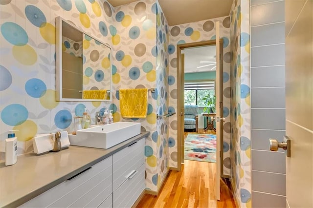 2400 Forest Ave, Kansas City, MO 64108 - full bath with wallpapered walls, wood finished floors, and vanity