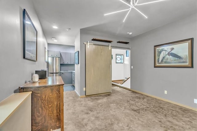 2400 Forest Ave, Kansas City, MO 64108 - unfurnished bedroom with stainless steel refrigerator, carpet floors, and a barn door