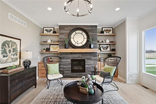 18608 Mohawk Ln, Overland Park, KS 66085 - living room featuring crown molding, light wood-style flooring, a tiled fireplace, recessed lighting, and a chandelier