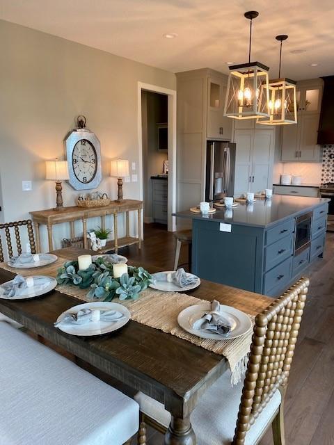 18608 Mohawk Ln, Overland Park, KS 66085 - dining area featuring dark wood-style floors and a chandelier