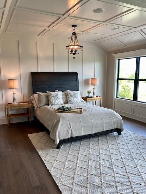 18608 Mohawk Ln, Overland Park, KS 66085 - bedroom featuring a decorative wall, wood finished floors, and coffered ceiling