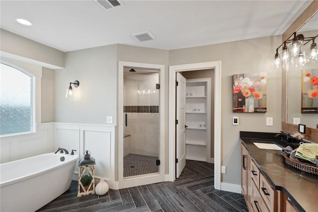 18608 Mohawk Ln, Overland Park, KS 66085 - full bathroom featuring a shower stall, vanity, a freestanding bath, and wainscoting