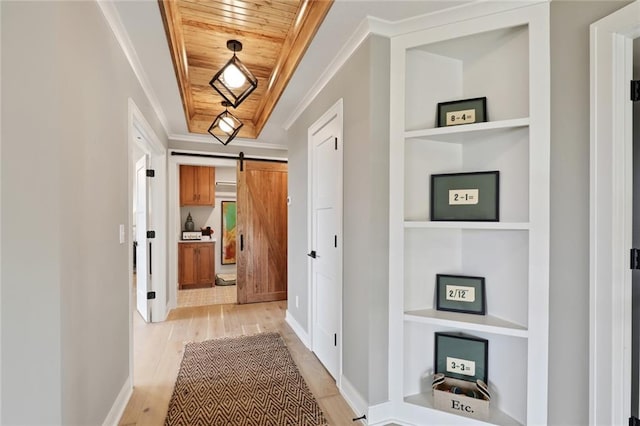18608 Mohawk Ln, Overland Park, KS 66085 - hallway featuring wood ceiling, built in features, a barn door, light wood-style flooring, and crown molding
