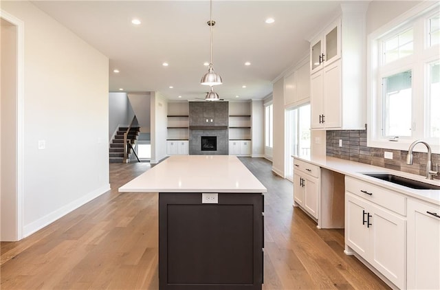3361 W 187th St, Overland Park, KS 66085 - kitchen with a tiled fireplace, open floor plan, plenty of natural light, white cabinets, and recessed lighting
