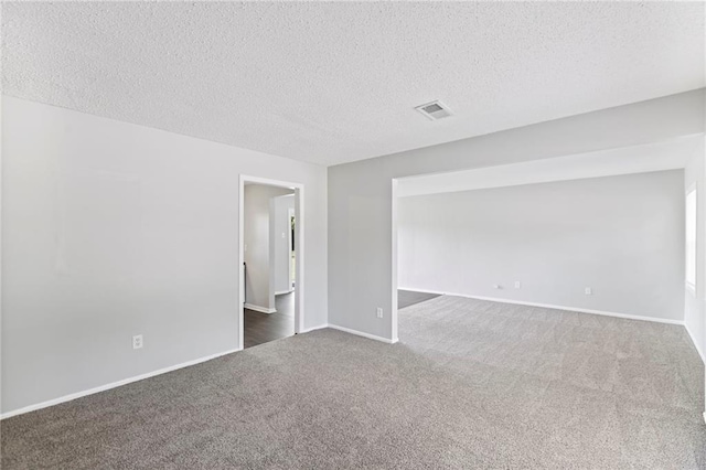 1313 S Clark Ave, Independence, MO 64057 - carpeted empty room featuring a textured ceiling and baseboards