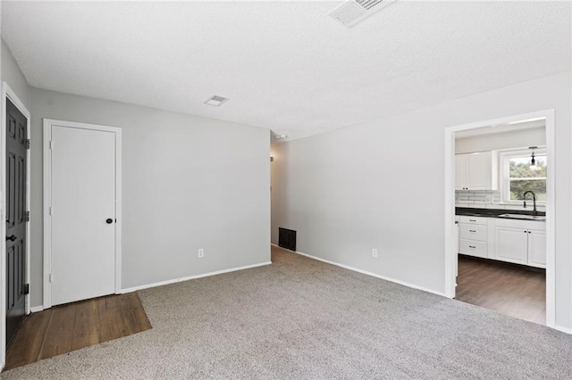 1313 S Clark Ave, Independence, MO 64057 - unfurnished room with a sink and dark carpet
