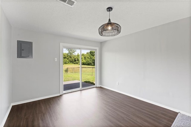 1313 S Clark Ave, Independence, MO 64057 - spare room with electric panel, dark wood-style flooring, and a textured ceiling