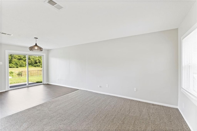 1313 S Clark Ave, Independence, MO 64057 - spare room with dark carpet and baseboards
