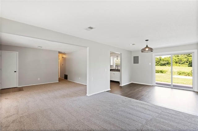 1313 S Clark Ave, Independence, MO 64057 - unfurnished living room featuring dark colored carpet and electric panel