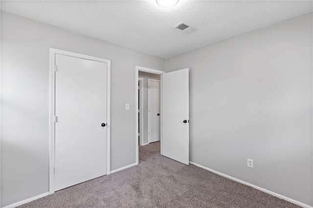 1313 S Clark Ave, Independence, MO 64057 - unfurnished bedroom with carpet floors and a textured ceiling