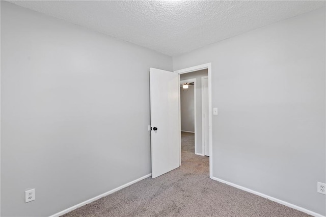1313 S Clark Ave, Independence, MO 64057 - empty room featuring carpet and a textured ceiling
