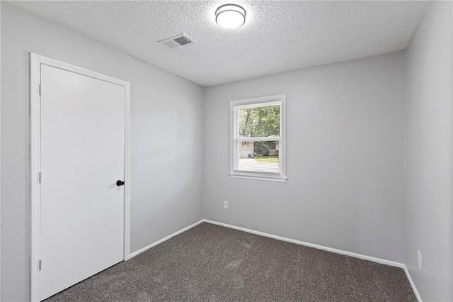 1313 S Clark Ave, Independence, MO 64057 - unfurnished room featuring dark colored carpet and a textured ceiling
