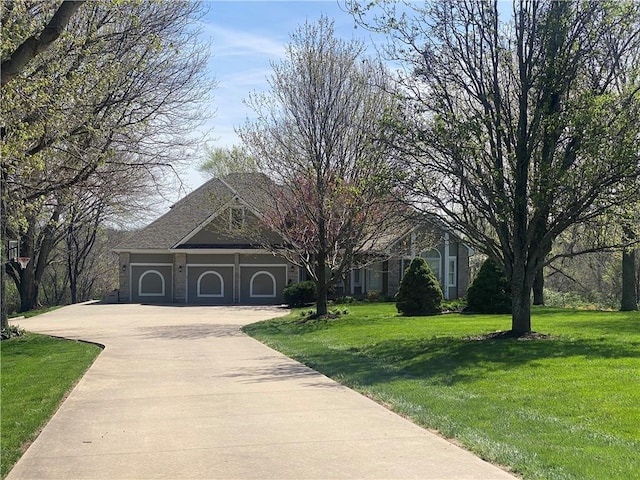 24445 E Truman Rd, Independence, MO 64056 - view of front facade with concrete driveway, a front lawn, and a garage