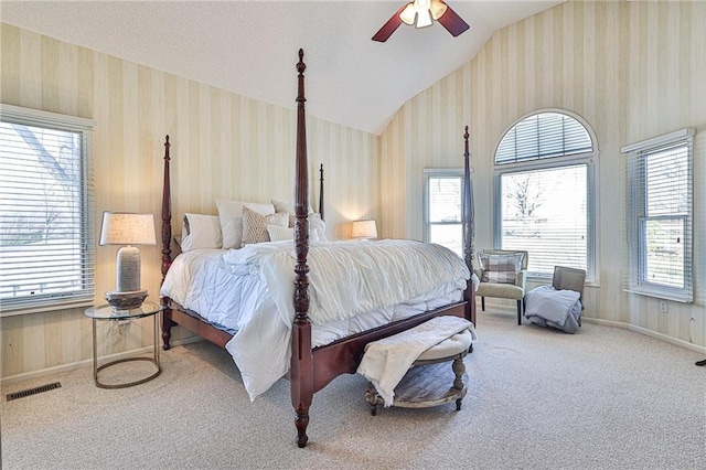 24445 E Truman Rd, Independence, MO 64056 - bedroom with wallpapered walls, vaulted ceiling, carpet floors, and ceiling fan