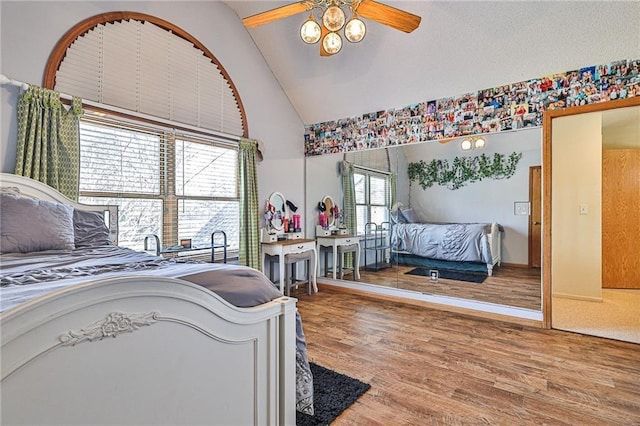 24445 E Truman Rd, Independence, MO 64056 - bedroom with wood finished floors, high vaulted ceiling, and a ceiling fan