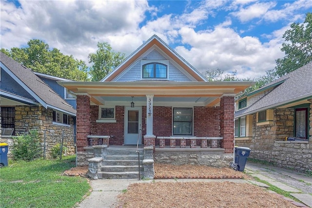 3923 Campbell St, Kansas City, MO 64110 - bungalow featuring a porch and brick siding